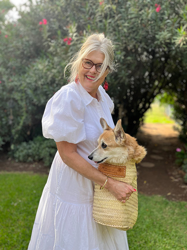 Picture of Catherine Beach and pup in a basket, on the farm in western NSW